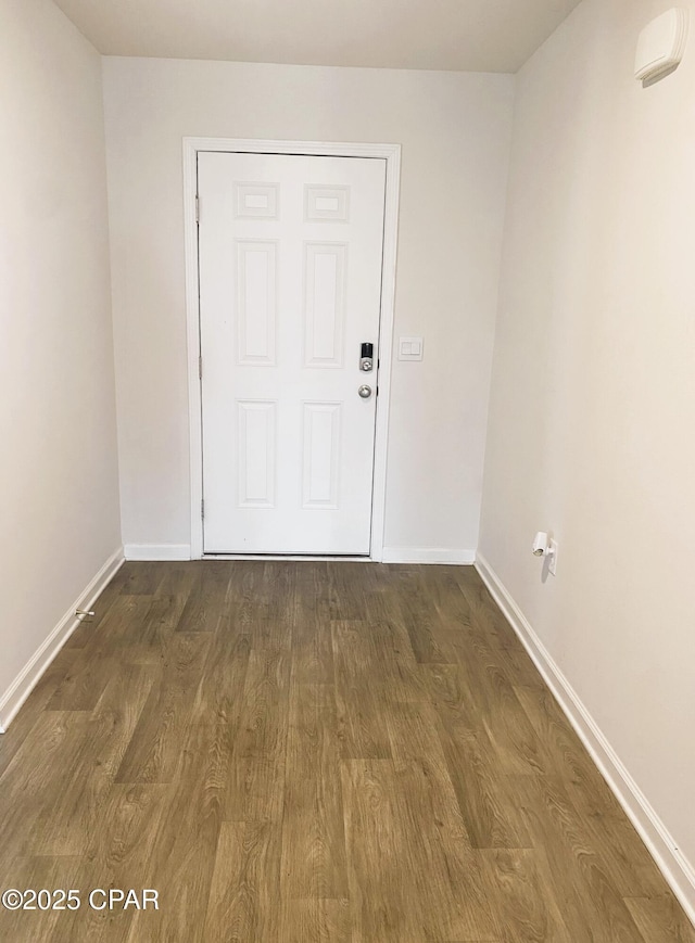 empty room with dark hardwood / wood-style flooring