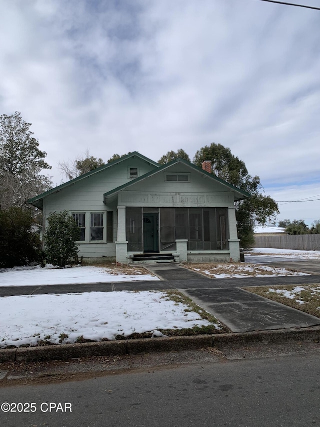 bungalow-style house with a sunroom