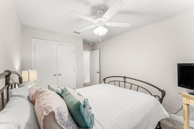 bedroom with ceiling fan, carpet floors, and a closet