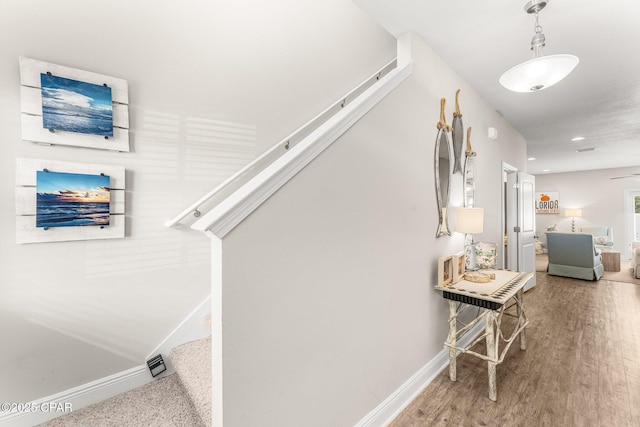 staircase with hardwood / wood-style flooring