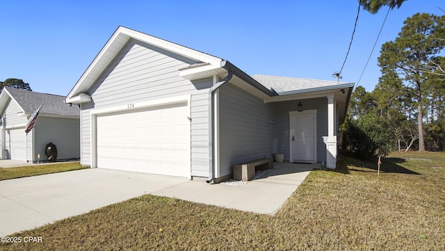 view of front of house with a garage and a front yard