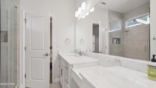 bathroom featuring vanity and a shower with shower door