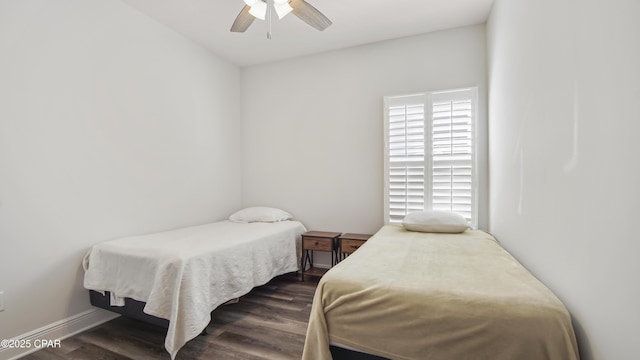 bedroom with dark hardwood / wood-style floors and ceiling fan