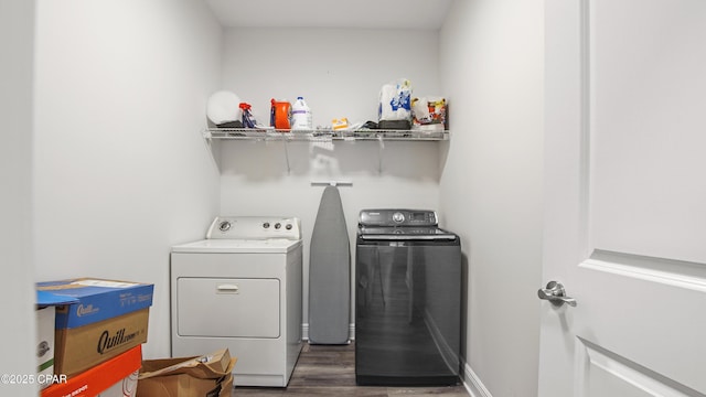 washroom featuring dark hardwood / wood-style flooring and washer and dryer