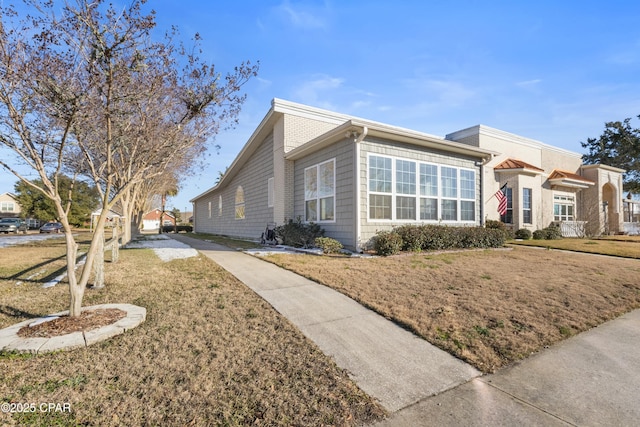 view of side of property with a yard