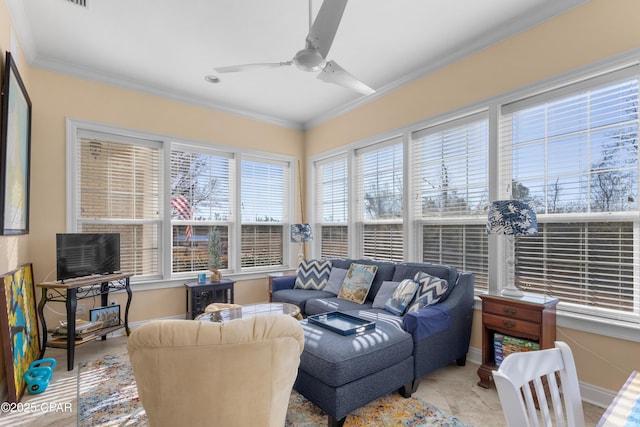 living room with ceiling fan, ornamental molding, and baseboards