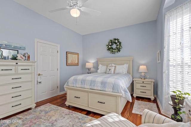 bedroom featuring dark wood-type flooring, baseboards, and a ceiling fan