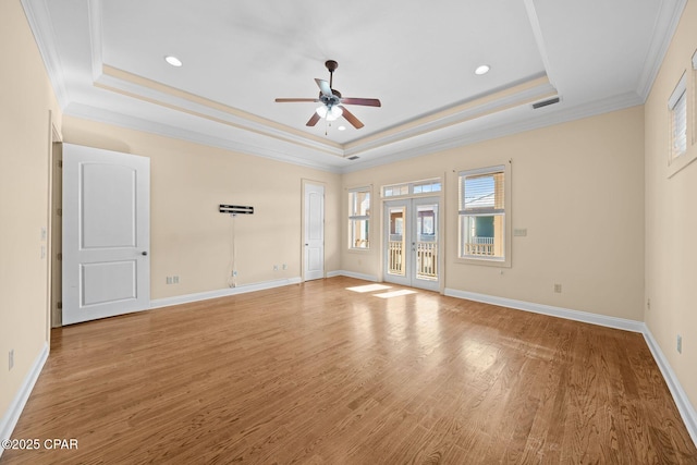 interior space with french doors, crown molding, wood-type flooring, a raised ceiling, and ceiling fan