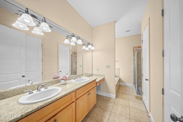 bathroom featuring tile patterned flooring, plus walk in shower, and vanity