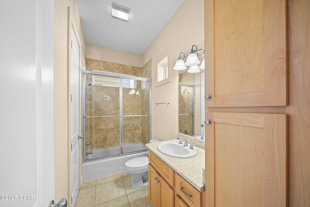 full bathroom with vanity, tile patterned flooring, shower / bath combination with glass door, and toilet