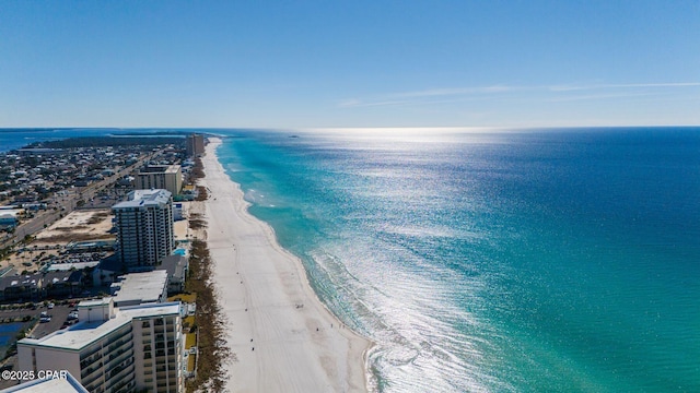 drone / aerial view featuring a view of the beach and a water view