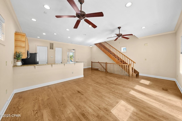 unfurnished living room featuring crown molding and light hardwood / wood-style flooring