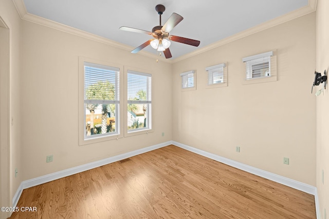 spare room featuring crown molding, ceiling fan, and light wood-type flooring