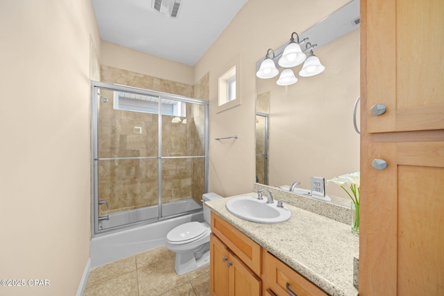 full bathroom with vanity, tile patterned floors, shower / bath combination with glass door, and toilet