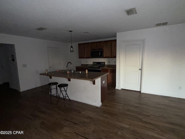 6610 Boat Race Rd, Panama City, FL 32404 - kitchen featuring electric range, dark wood-type flooring, a sink, a kitchen bar, and an island with sink