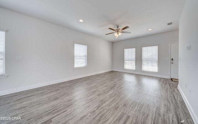 spare room with ceiling fan and wood-type flooring