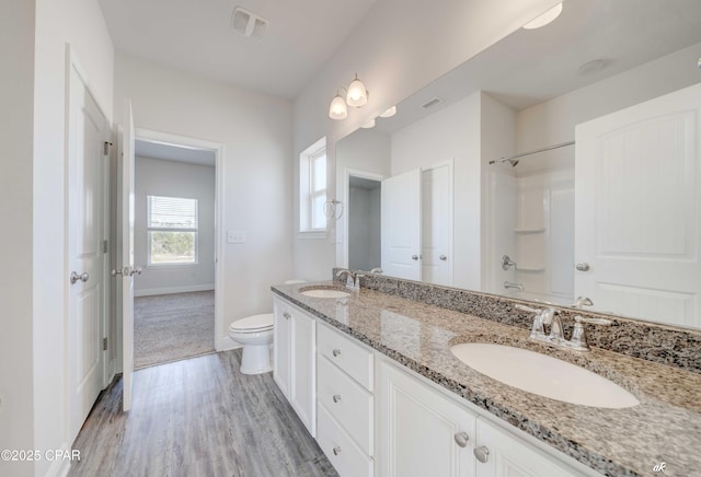 bathroom with vanity, hardwood / wood-style flooring, and toilet