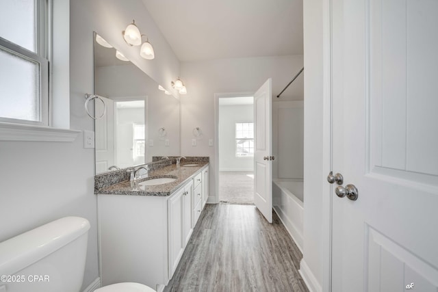 full bathroom featuring vanity, shower / bathing tub combination, hardwood / wood-style flooring, and toilet