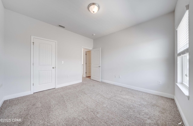 unfurnished bedroom with multiple windows and carpet