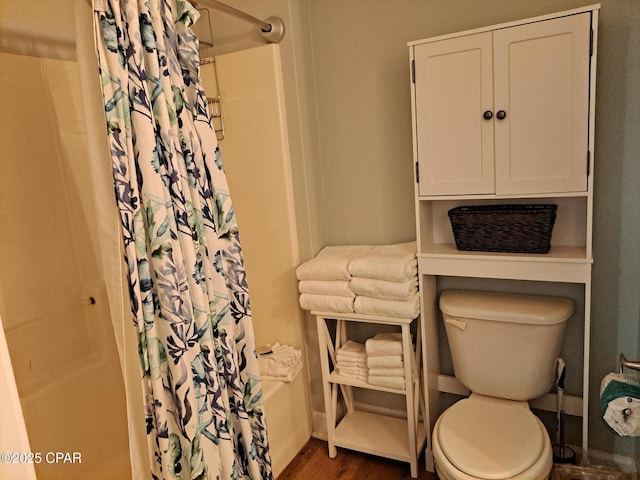 bathroom featuring hardwood / wood-style floors and toilet