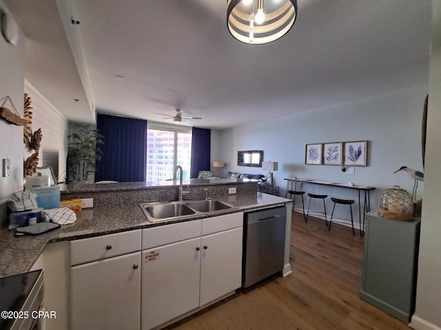 kitchen featuring white cabinetry, dark hardwood / wood-style floors, dishwasher, and sink