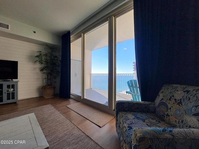 unfurnished living room with wood-type flooring and a water view