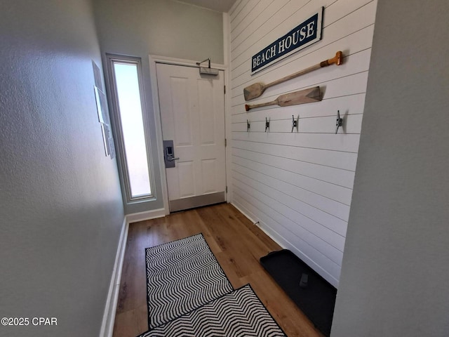 mudroom with wooden walls and light hardwood / wood-style flooring