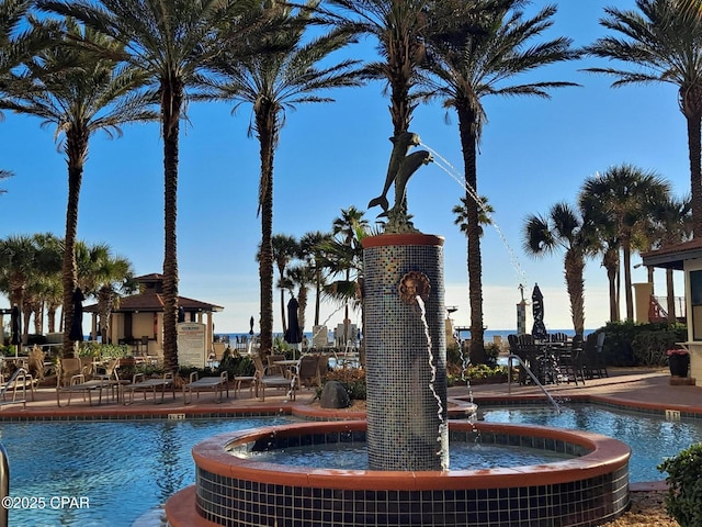 view of swimming pool with pool water feature