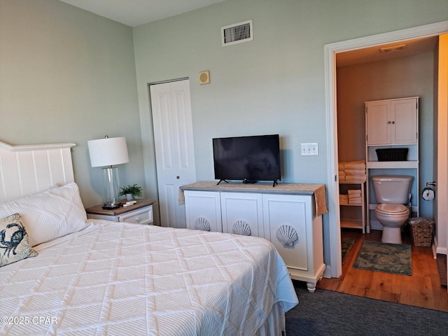 bedroom with hardwood / wood-style flooring and a closet