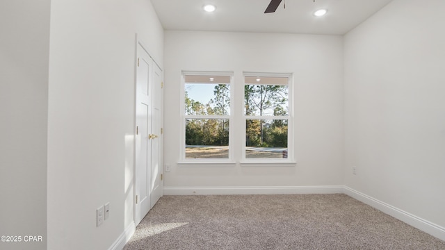 spare room featuring carpet floors and ceiling fan