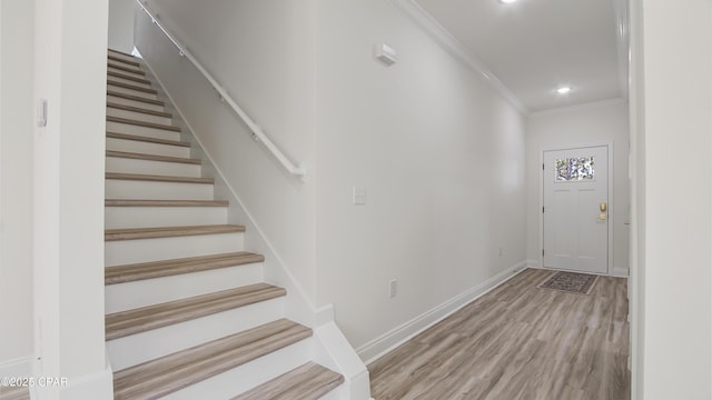 entryway featuring crown molding and wood-type flooring