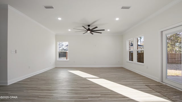 spare room with hardwood / wood-style flooring, ornamental molding, and ceiling fan