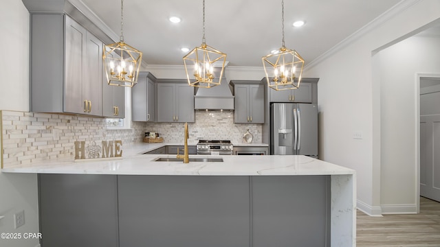 kitchen with gray cabinets, pendant lighting, light stone counters, kitchen peninsula, and stainless steel appliances