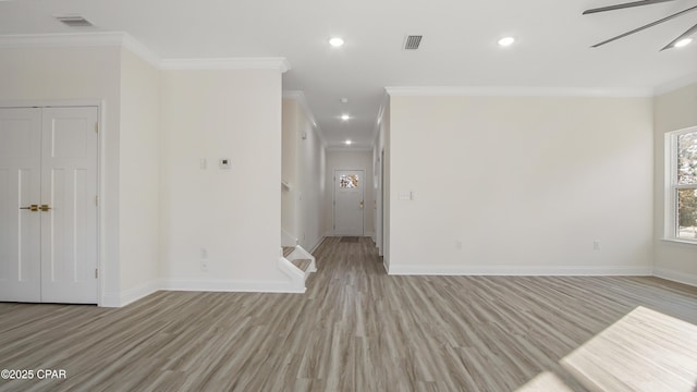 unfurnished room featuring ceiling fan, ornamental molding, and light hardwood / wood-style flooring