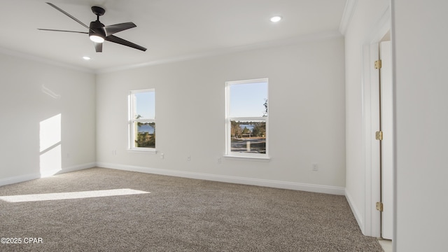 carpeted spare room featuring ornamental molding and ceiling fan