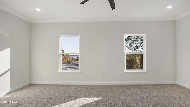 unfurnished room with ceiling fan, ornamental molding, carpet floors, and plenty of natural light