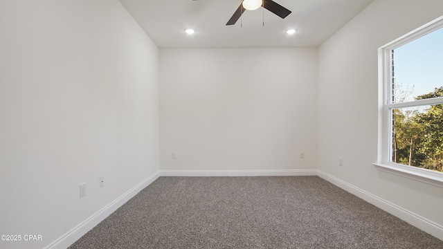 carpeted spare room with ceiling fan and a healthy amount of sunlight