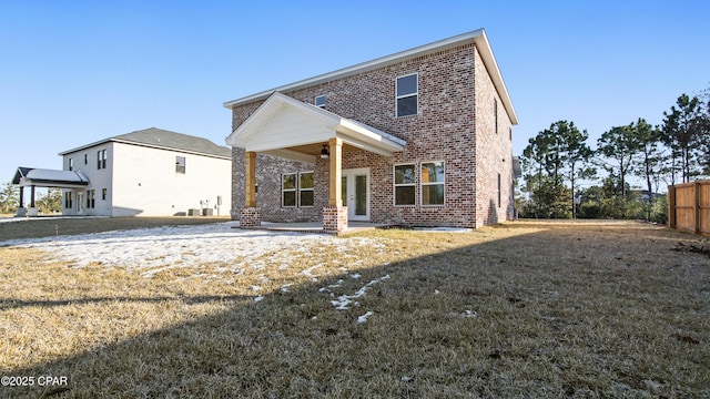 rear view of property featuring a patio area, ceiling fan, and a lawn