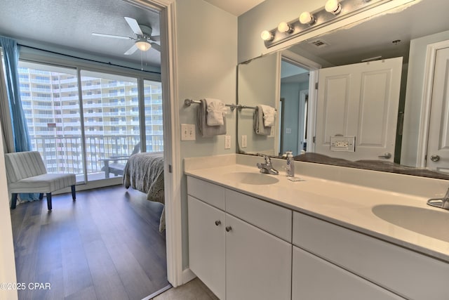 bathroom featuring vanity, hardwood / wood-style floors, and ceiling fan