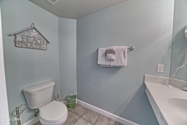 bathroom with tile patterned flooring, sink, and toilet