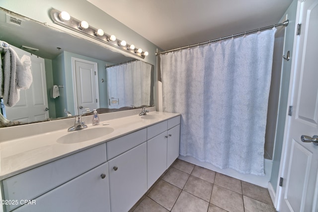 bathroom with vanity, tile patterned floors, and shower / bath combo with shower curtain