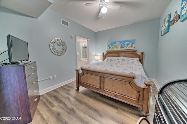 bedroom with connected bathroom, hardwood / wood-style floors, and ceiling fan