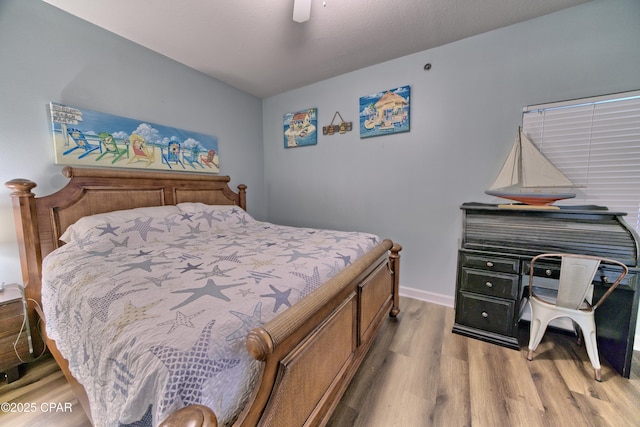 bedroom with light hardwood / wood-style flooring and ceiling fan