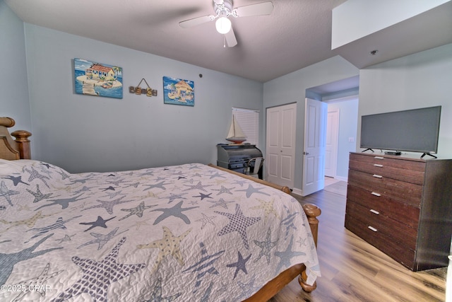 bedroom with hardwood / wood-style floors, ceiling fan, and a closet