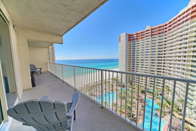 balcony featuring a water view and a view of the beach