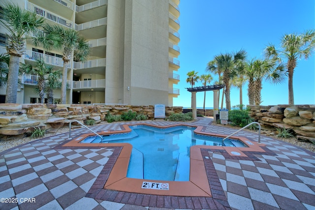 view of swimming pool featuring a patio area and a pergola