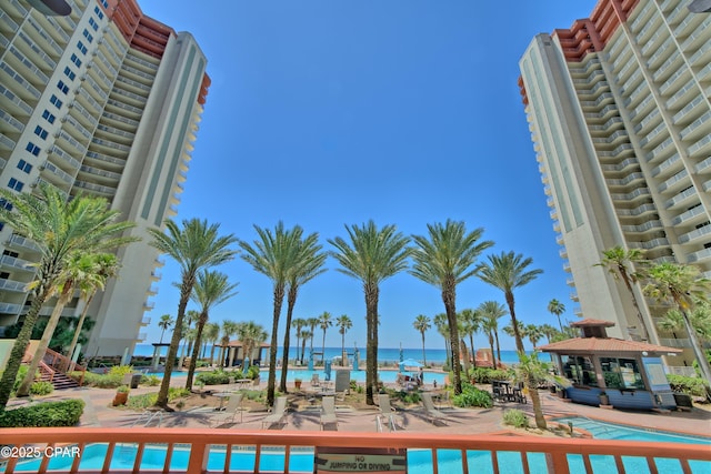 view of swimming pool featuring a water view, a patio, and a gazebo