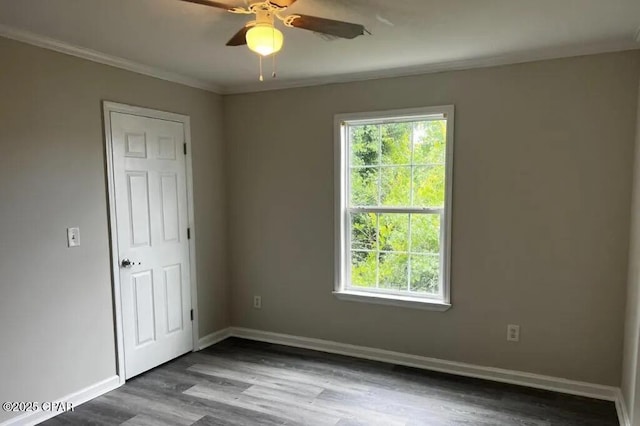 empty room with ornamental molding, hardwood / wood-style floors, and ceiling fan