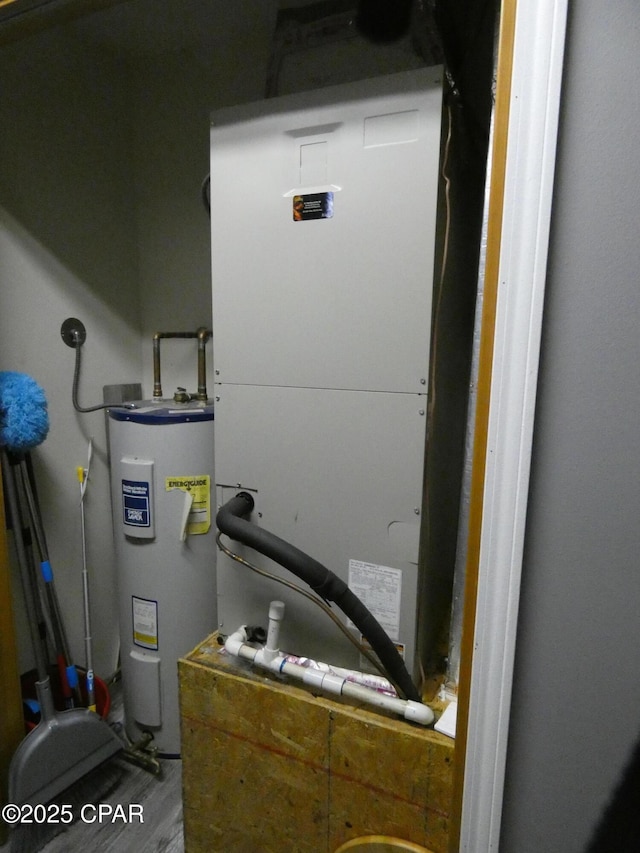 utility room with water heater and heating unit