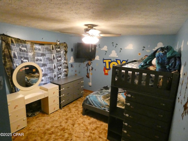 bedroom with ceiling fan and a textured ceiling